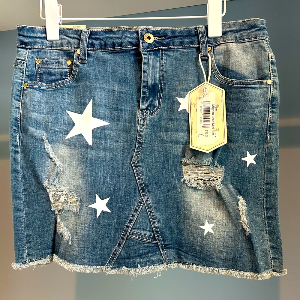 NWT Mignon Jean skirt. Size large. Denim with star pattern. Distressed detail.